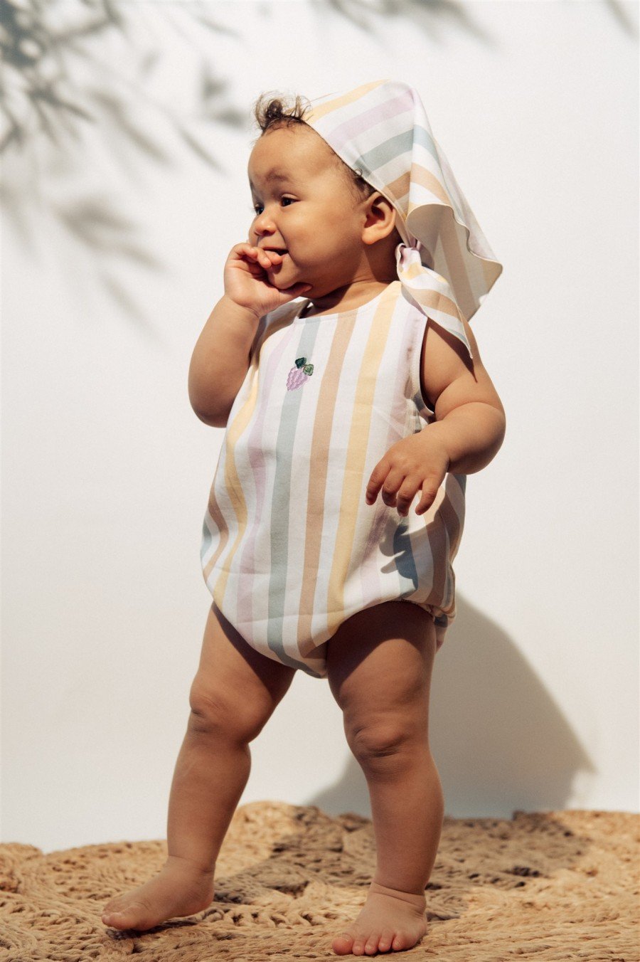 Short romper with pastel stripes and embroidery SS23185